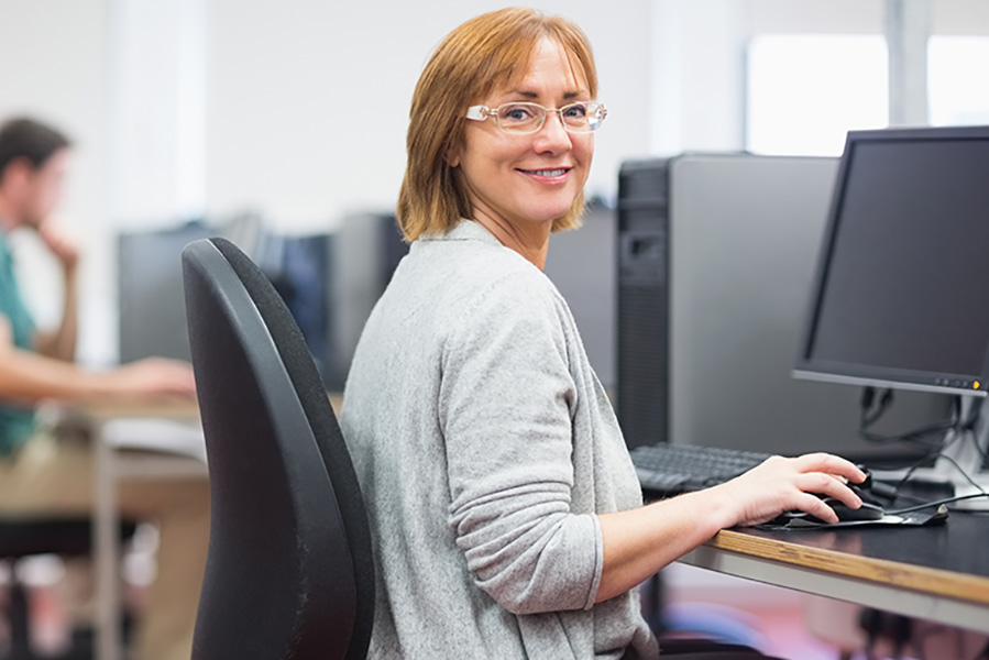 an adult female working at a computer