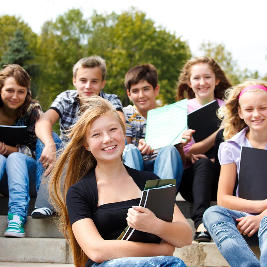 Goup of teenagers having fun outside of school