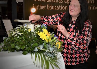 Lisa Corcoran lighting candle of remembrance